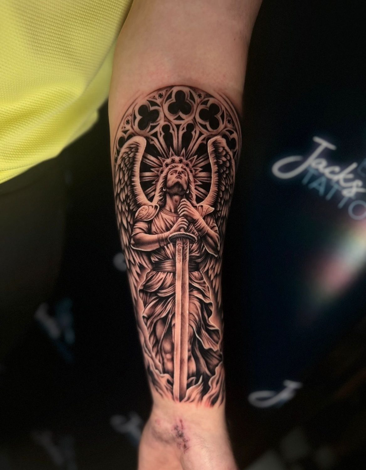 Black and grey archangel with sword and gothic window tattoo