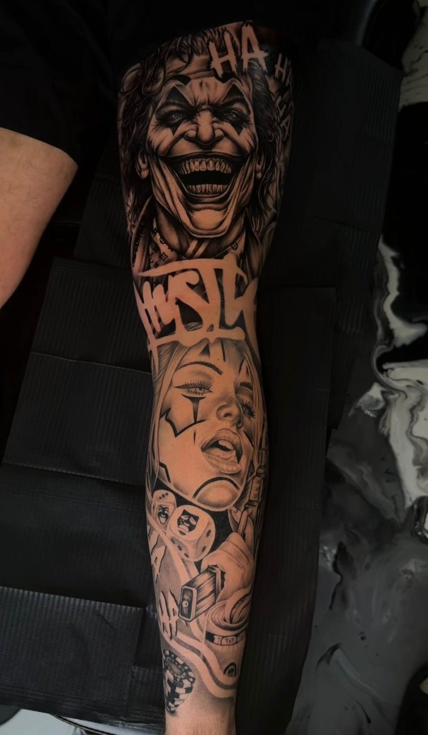 Black and grey Joker and Harley Quinn clown sleeve tattoo