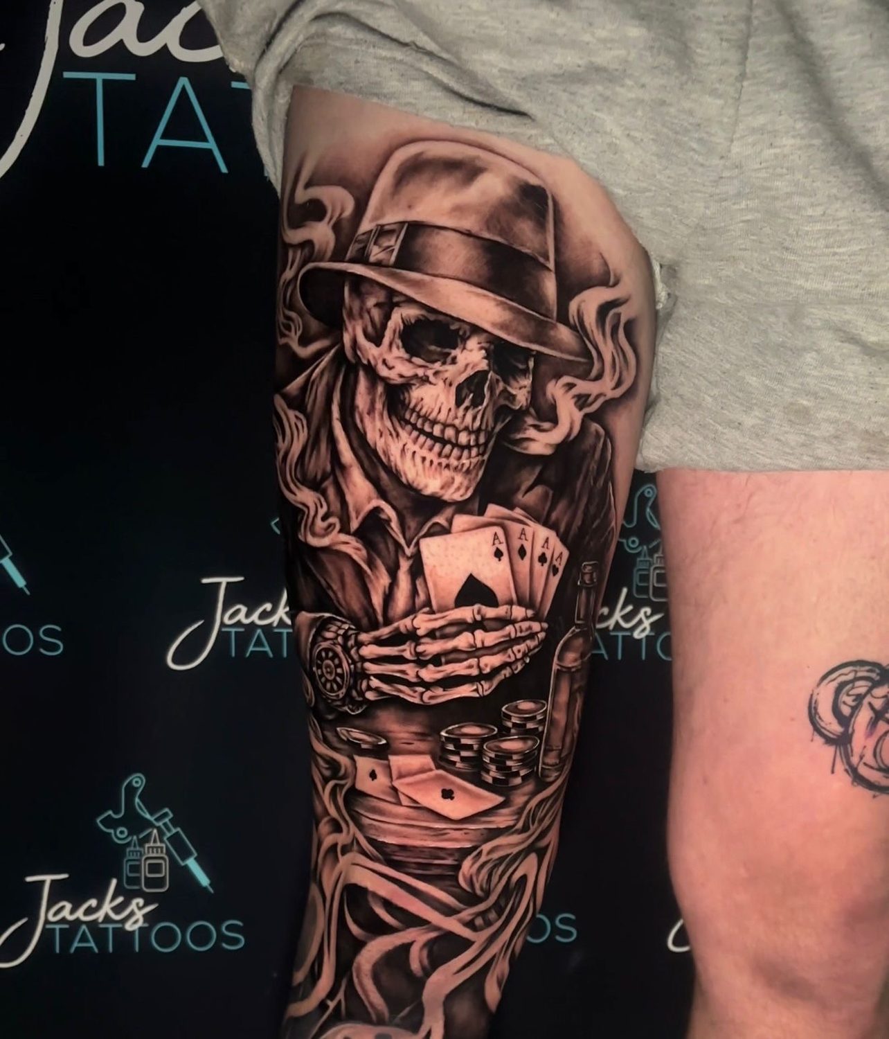 Black and grey skeleton gambler with cards and smoke tattoo