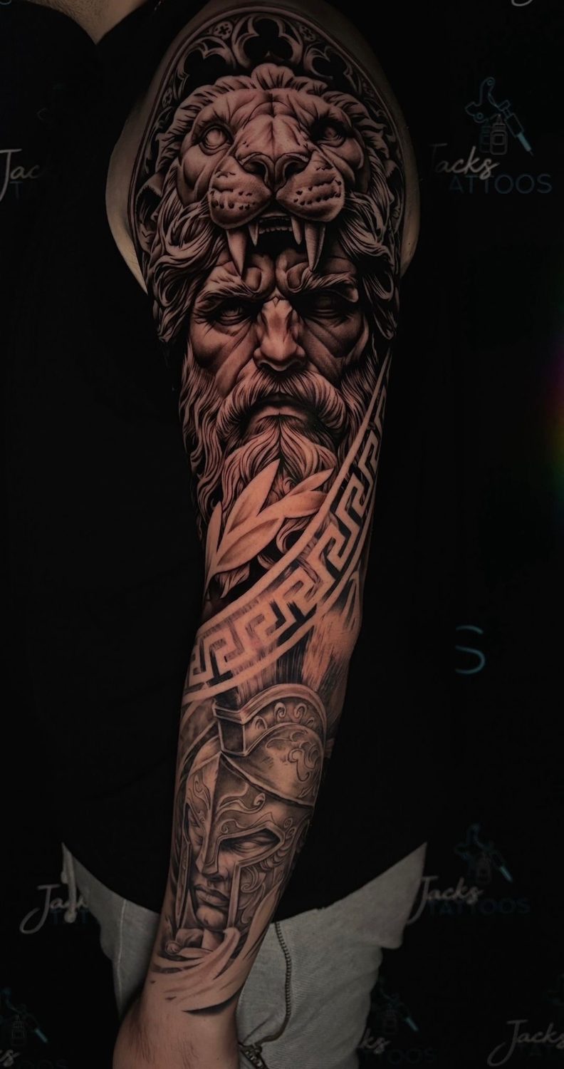 Black and grey Greek god with lion headdress arm sleeve tattoo