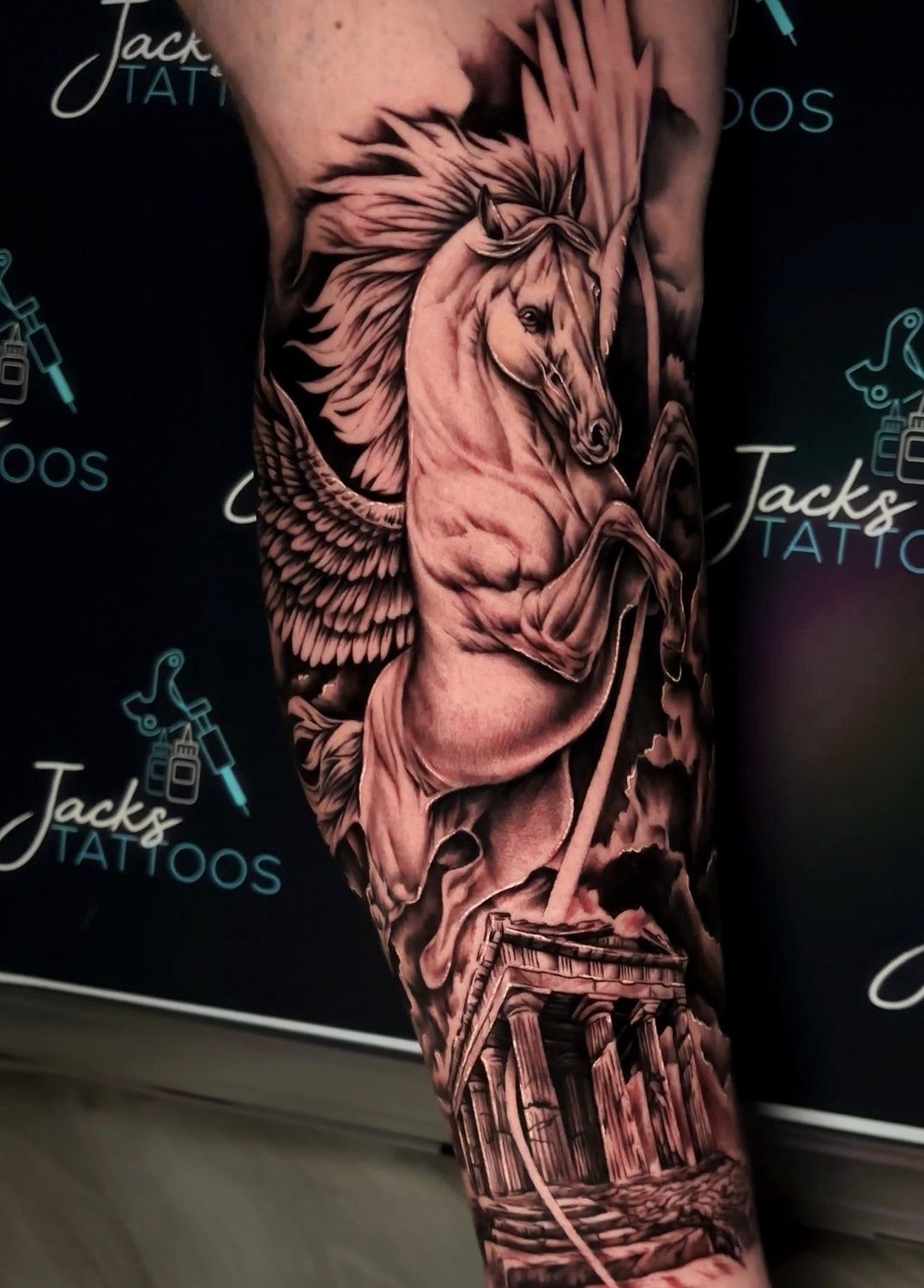 Black and grey winged Pegasus and Greek temple sleeve tattoo