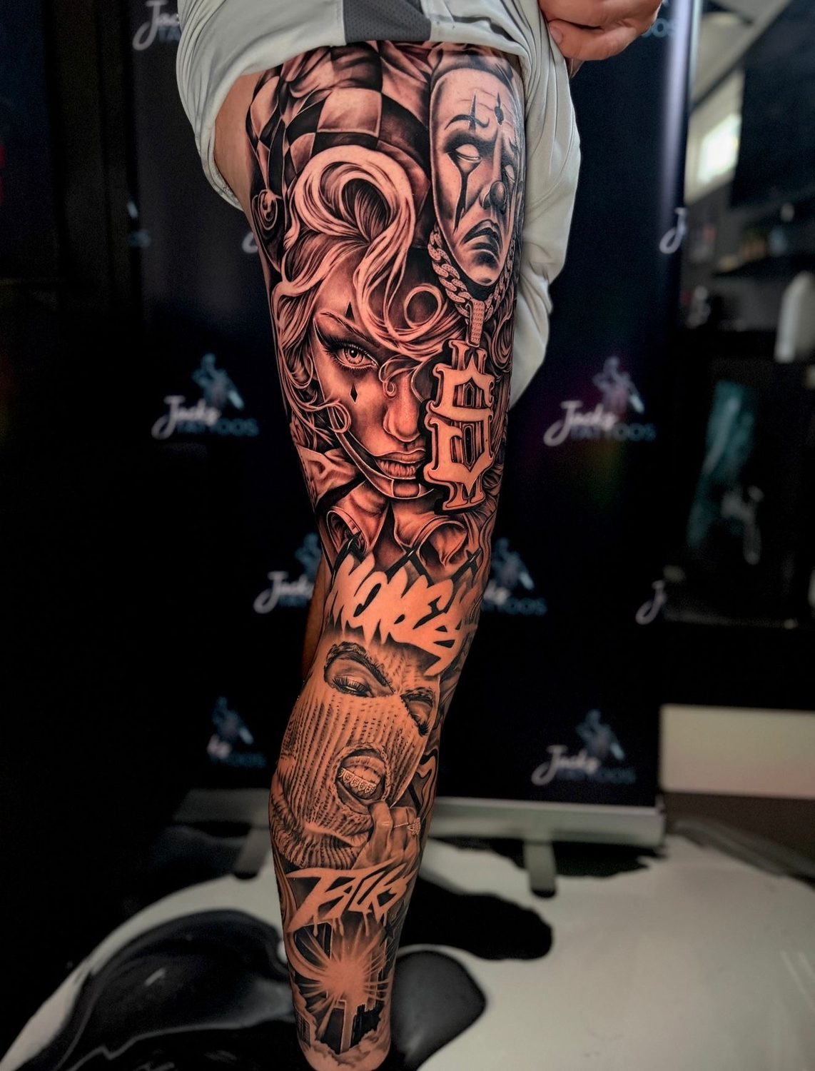 Black and grey chicano Medusa and clown leg sleeve tattoo